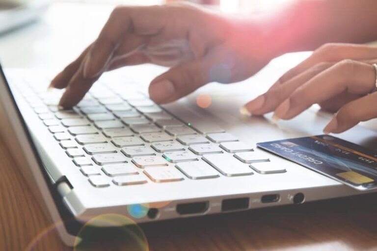 Hands typing on a white keyboard