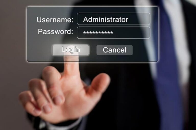 Hand touching a screen with administrator username and password fields