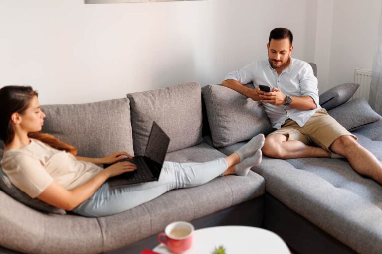 Man using a laptop while sitting on a couch