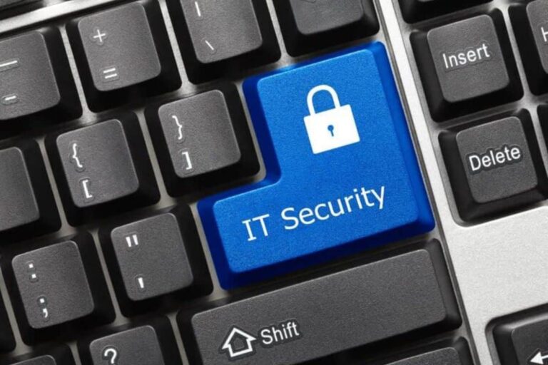 Blue IT Security padlock key on a black keyboard